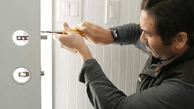 Man screwing in door hardware